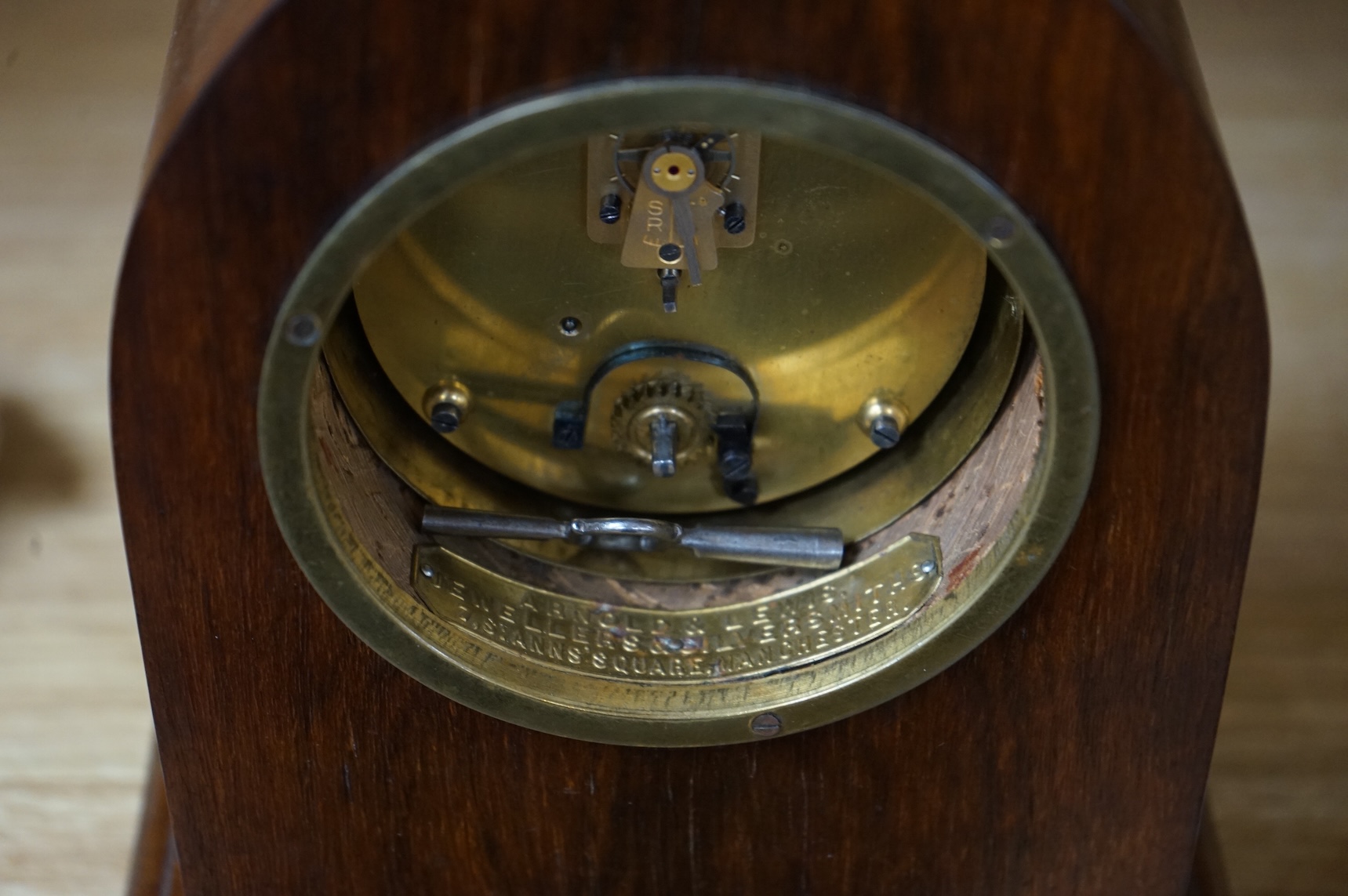 An Edwardian inlaid mahogany lancet shaped eight day mantel timepiece, with key, 23cm high